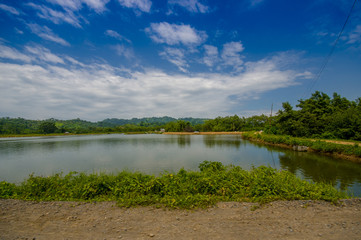 Lake in in the coast of Same, surrounded with abundat vegetation in a sunny day in the Ecuadorian coasts