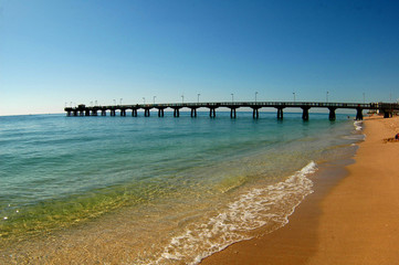 pier into ocean off of beach 