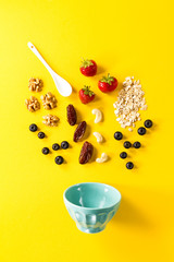 Tasty healthy natural ingredients for breakfast on yellow vibrant background. Breakfast Morning Food Concept.