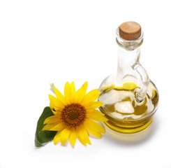 Sunflower and glass bottle of oil isolated on white background