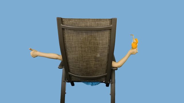 Young caucasian girl sitting on chair, drinking orange juice cocktail straw and thumbs up show.