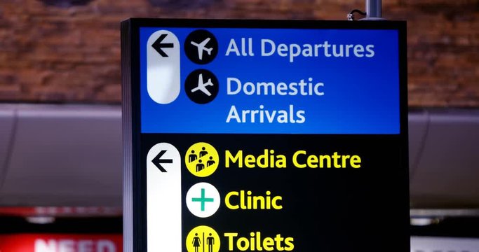 Directional signs at airport terminal