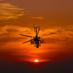 Attack helicopter at sunset. after the mission