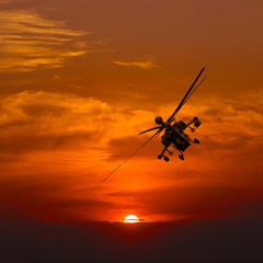 Naklejka na ściany i meble Attack helicopter at sunset. after the mission