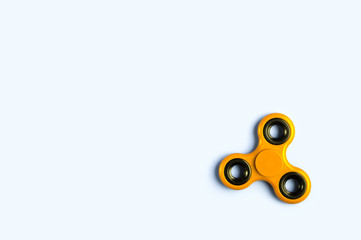 Fidget spinner background template with copy space. Popular kids stress and anxiety relief toy in the bottom right corner.