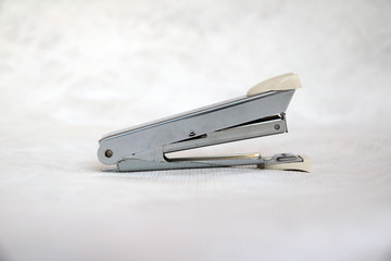 metal stapler  isolated on white background. a device for fastening together sheets of paper.