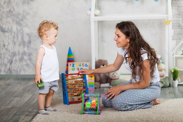 mother and her son play together indoor