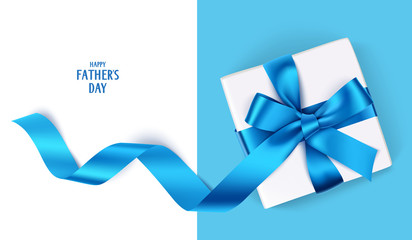 Decorative gift box with blue bow and long ribbon. Happy Father's Day text. Top view - 165599383