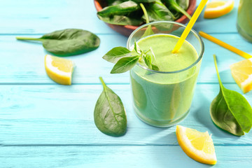 Glass of fresh juice on wooden background