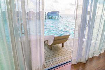 Beautiful tropical Maldives resort hotel with beach and blue water .