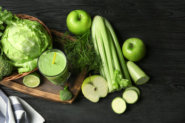 Glass of fresh vegetable juice on wooden background