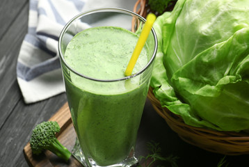 Glass of fresh vegetable juice on table