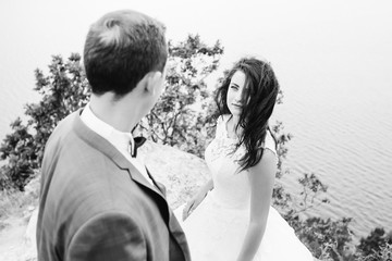 Happy woman smiling at her husband. Look from behind groom's bac