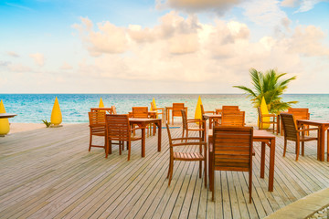 Table and chairs at restaurant in tropical Maldives island .