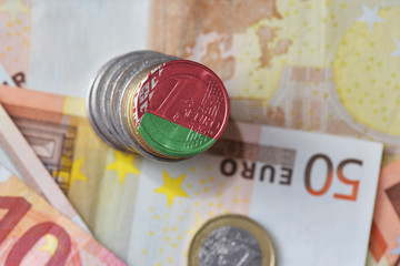 euro coin with national flag of belarus on the euro money banknotes background