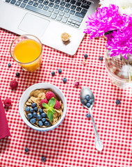 Multigrain wholewheat healthy cereals with fresh berry and a glass of juice for breakfast
