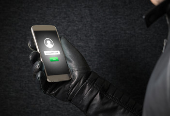 Identity theft and cyber security concept. Mobile hacker and criminal login to persons online...