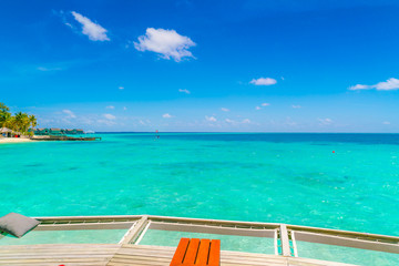 Fototapeta premium Vacation net seat in tropical Maldives island and beauty of the sea with the coral reefs .