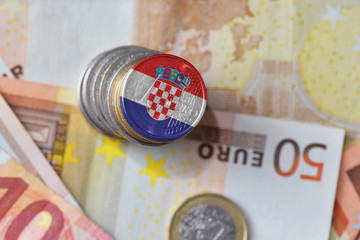 euro coin with national flag of croatia on the euro money banknotes background. © luzitanija