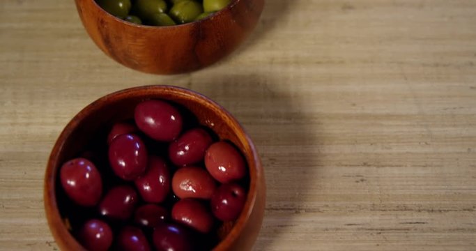 Red and green olives kept in bowl on counter