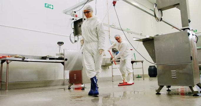 Butchers cleaning floor