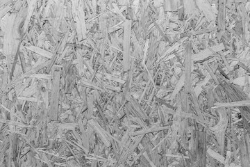 Close-up of a particle board background texture in black and white.