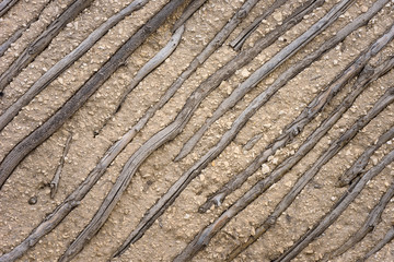 Wall of natural wood and clay. Ancient architecture, handmade. Background texture. Rustic style.