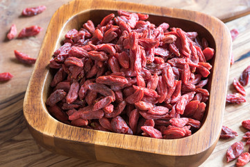 Dried goji berries in a wooden bowl