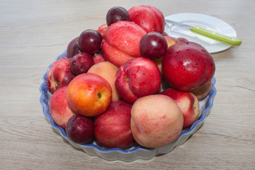 Juicy peaches, nectarine and plums on the kitchen table. fruit on the table