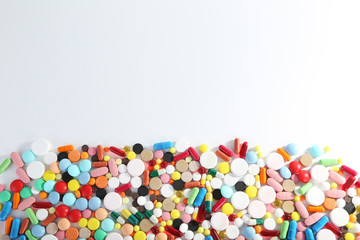 Fototapeta na wymiar Different colorful pills on white background
