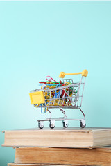 Shopping cart with paperclips on books