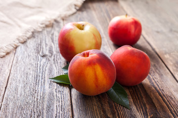 Naklejka na ściany i meble Peaches and apples on a wooden table
