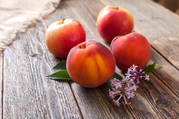 Peaches and apples on a wooden table