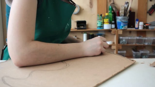 Woman in workshop cutting wood