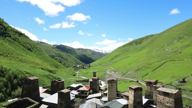 timelapse of Sky with clouds and mountains Svan towers in Ushguli, Georgia.