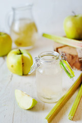 Summer refreshing drink, compote of apple and rhubarb on a light background