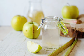 Summer refreshing drink, compote of apple and rhubarb on a light background - obrazy, fototapety, plakaty