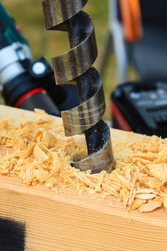 Metal machine drilling in wooden board