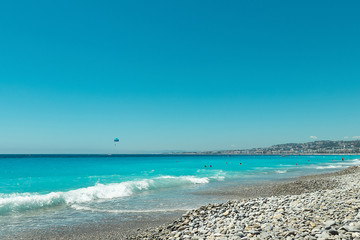 Crowded Mediterranean summer beach in City of Nice
