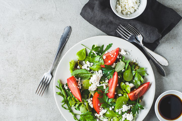 Fresh tomato salad in a grey ceramic plate. Diet or clean eating concept