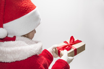 Baby holding Christmas gift on white background