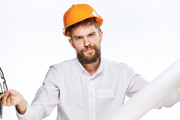Engineer with a beard on a white isolated background holds blueprints