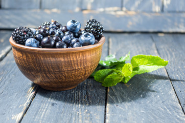Sweet forest berries in a clay bowl.