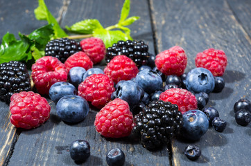 Fresh forest berries. Berries and a green leaf.