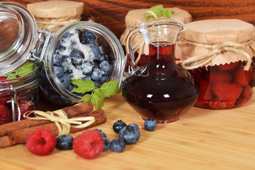 Sweet blueberries and raspberries in jars for winter