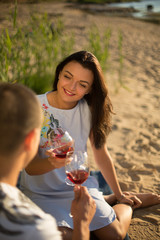 A young couple in love, on the shore of the Bay at sunset