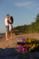 A young couple in love, on the shore of the Bay at sunset