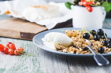 Muesli with ice cream and currants on a plate
