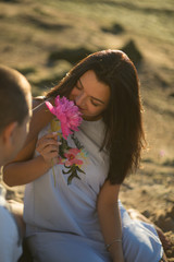 A young couple in love, on the shore of the Bay at sunset