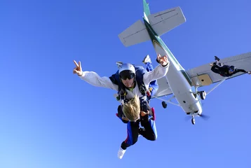 Tuinposter Skydiving tandem jump from the plane © Mauricio G